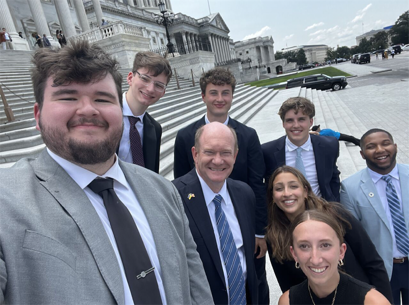 Aiken (far right) with Sen. Chris Coons and fellow interns in summer 2022.