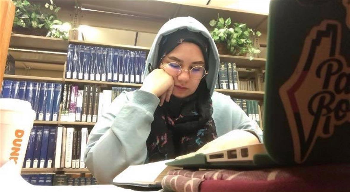 Nada Abuasi studying at the library.