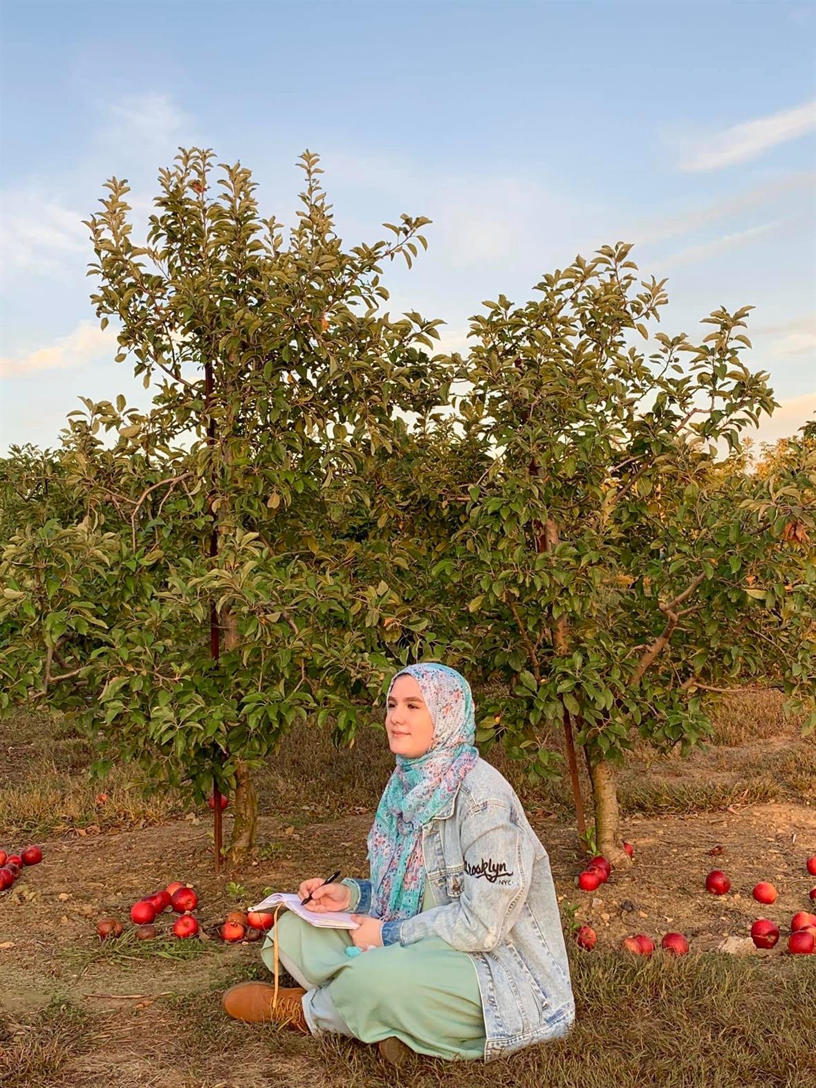 Nada Abuasi in apple orchard
